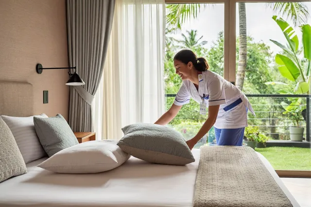 Nurse checking the blood pressure of a patient recovering after surgery at home in Bali